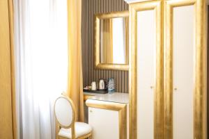 a bathroom with a toilet and a mirror at Duomo Boutique Hotel in Chioggia