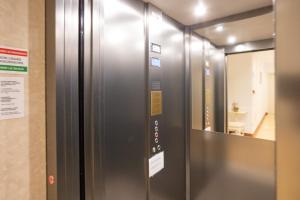 an elevator in a room with a mirror at Duomo Boutique Hotel in Chioggia