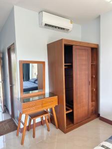 a dressing table with a mirror and a dresser at Triple O Phala Beach in Ban Phala