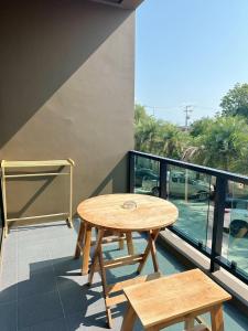 a table and benches on a balcony with a view at Triple O Phala Beach in Ban Phala