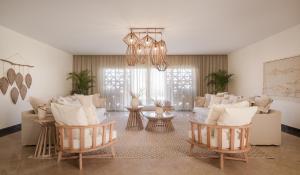 a living room with white furniture and a chandelier at The Zen Wellness Resort in Aswan