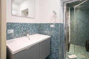 a bathroom with a sink and a shower at Duomo Boutique Hotel in Chioggia
