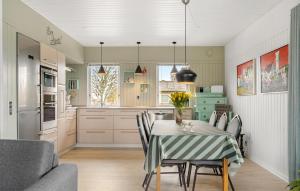 a kitchen and dining room with a table and chairs at Pet Friendly Home In Sams With Kitchen in Ballen
