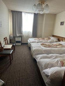 Postel nebo postele na pokoji v ubytování Naeba Lodge Oka