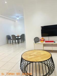 a room with a table and a tv on a wall at FF9 HOMESTAY in Alor Setar +4 photos