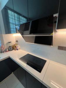 a kitchen with a microwave and a stove at FF9 HOMESTAY in Alor Setar