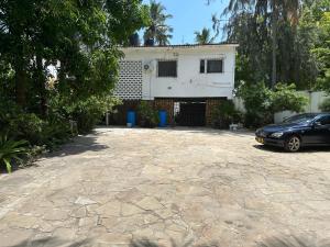 a car parked in front of a house at Heidi’s Beach Stay in Mombasa