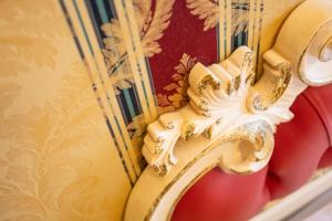 a close up of a gold dragon on a wall at Duomo Boutique Hotel in Chioggia