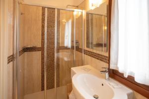 a bathroom with a shower and a sink and a toilet at Duomo Boutique Hotel in Chioggia