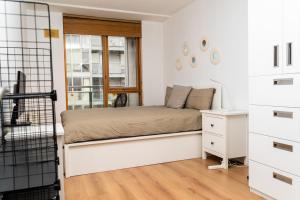 a small bedroom with a bed and a desk at Stunning 1 bedroom appartment in Grand Cannal in Dublin