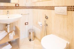 a bathroom with a white toilet and a sink at Duomo Boutique Hotel in Chioggia