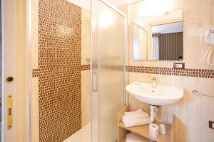 a bathroom with a sink and a shower at Duomo Boutique Hotel in Chioggia