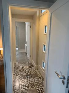 a hallway with a bathroom with a tile floor at Kilmoon Cottage, Entire home in Lisdoonvarna in Lisdoonvarna