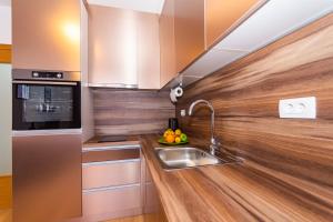 a kitchen with a sink and a counter top at Apartman Krželj A2 in Livno