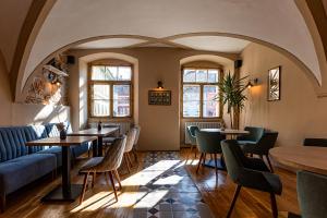 ein Restaurant mit Tischen und Stühlen und einer Couch in der Unterkunft Hotel Casa Wagner in Sighişoara