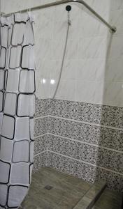 a shower with a black and white tile at Bilol Guest House in Samarkand +13 photos