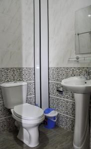 a bathroom with a toilet and a sink at Bilol Guest House in Samarkand