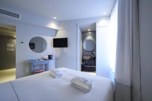 Posteľ alebo postele v izbe v ubytovaní Boutique Hotel de la Ville