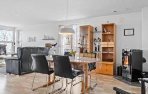 a dining room with a table and black chairs at 3 Bedroom Cozy Home In Aabenraa in Aabenraa