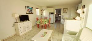 a living room with a kitchen and a dining room at 3 pièces proche plage commerces et golf in Pornic