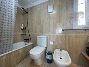 a bathroom with a white toilet and a sink at Sea view el veril in Adeje
