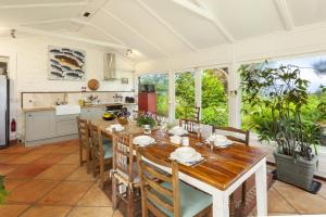 a kitchen and dining room with a wooden table and chairs at Chapel Knap Porlock Weir in Porlock