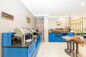 a kitchen with blue cabinets and a counter at Moonlight Elegance Boutique Hotels in Istanbul