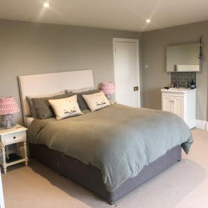 a bedroom with a large bed with two pillows at Upper Stowe in Church Stowe