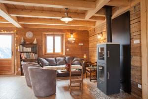 a living room with a couch and a table at Chalet La Trafolée in Manigod