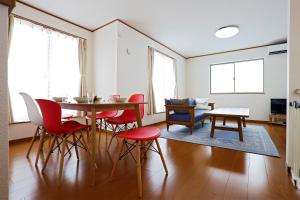 a living room with a table and red chairs at iruka - Vacation STAY 19721v in Nago