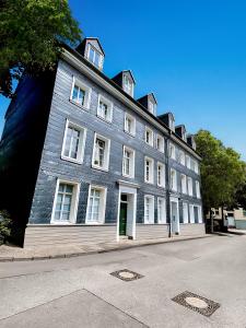 a large gray building with white windows on a street at Perfect for 6 guests Kitchen Parking Netflix in Wuppertal