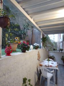 a patio with a table and chairs and potted plants at La Casa di Antonella in Agrigento