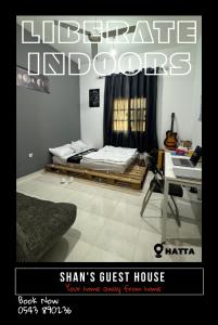 a magazine picture of a bedroom with a bed and a desk at Shan Studio Apartment in Hatta