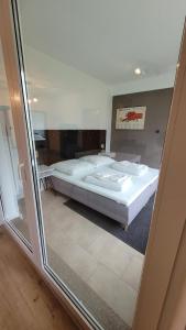 a bedroom with two beds and a glass window at Land.Natur.Erholen. in Wolgast