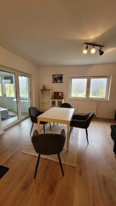 a living room with a table and chairs at Land.Natur.Erholen. in Wolgast