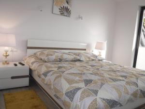 a bedroom with a large bed and a nightstand with a bed sidx sidx sidx at Villa LUX Luis in Dziwnów
