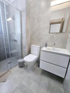 a bathroom with a toilet and a shower and a sink at New, Modern Studio, Universal Residences in Paphos City