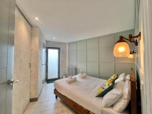 a bedroom with a bed with a light on the wall at Lovely contemporary ground floor apartment. in Dean