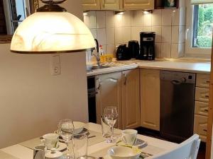 a kitchen with a table with wine glasses on it at Dabki Village in Dąbki