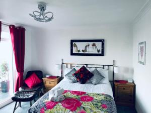 a bedroom with a bed and a chandelier at "The Celebration" Balcony Seafront Apartment in Eastbourne