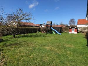 a yard with a playground with a slide at Great house in beautiful surroundings in Aalborg