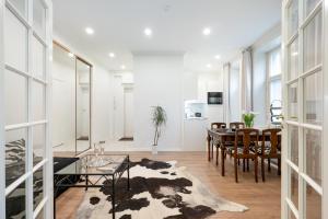 a living room with a table and chairs and a dining room at Cosy, brand new apartment in best area in Helsinki