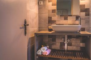 a bathroom with a sink and a counter with towels at Villa Jasmin Studios 2 in Gouvia