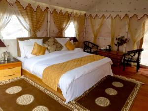 a bedroom with a large bed in a tent at Royal Deluxe Camp & Resort, Hunder- Nubra in Nubra