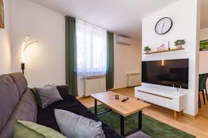 a living room with a couch and a table at Apartman Krželj B2 in Livno