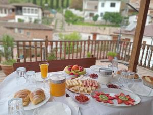 a table with plates of food and fruit on it at DD Villa in Berat