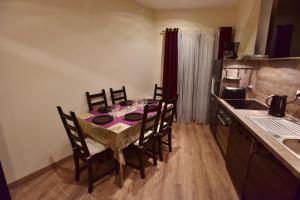 a kitchen with a table with chairs and a table cloth at Loft Deluxe du Moulin Vert in Paris