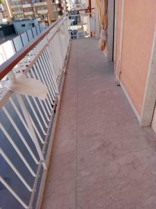 a corridor of a building with a metal railing at Casa vacanze ferro in Trapani