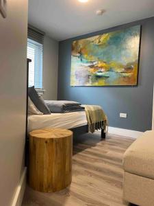 a bedroom with a bed and a painting on the wall at “ The Art House 4” Galway, Woodquay in Galway