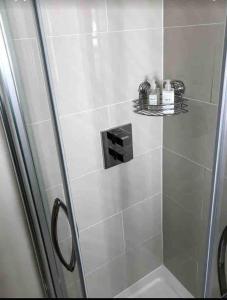 a bathroom with a shower with a glass door at 2 Bed Cottage - Sleeps 4 - Parking - Wifi in Bridgnorth